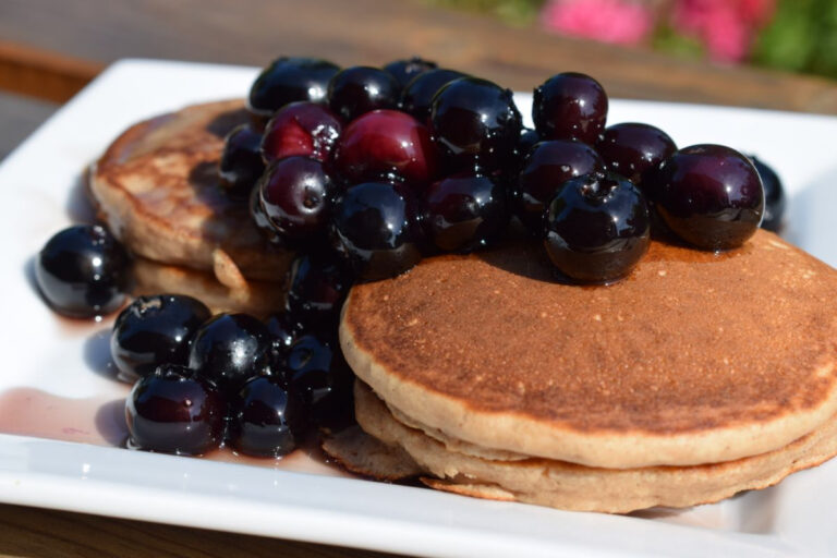 close up of super fluffy gluten free pancakes topped with blueberry compote